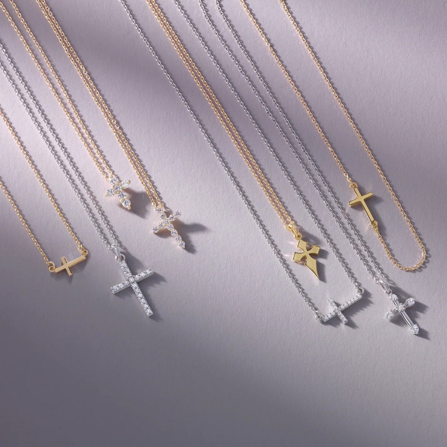 Elegant fine gold and silver cross pendants with sparkling details.