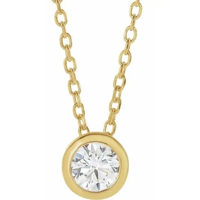 Close-up photo of 0.10ct solitaire diamond necklace in 14K gold, handcrafted in NYC.