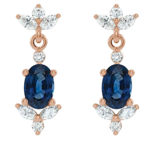 Close-up of handcrafted 14K gold sapphire and diamond dangle earrings