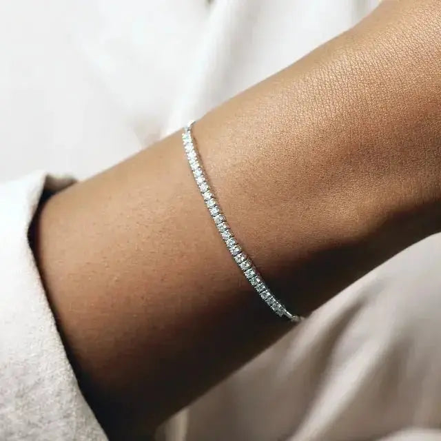 Close-up of 14K Gold Bolo Bracelet on wrist, highlighting its delicate design and shimmering diamonds. A timeless piece for any occasion.
