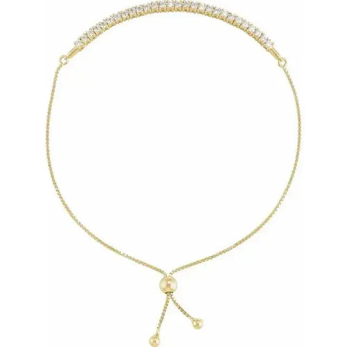 Close-up photo of 14K gold adjustable bolo bracelet with minimalist design, handcrafted in NYC.