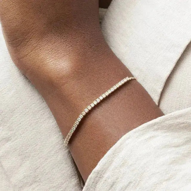Elegant 14K Gold Bolo Bracelet worn on wrist, showcasing its adjustable fit and sparkling diamond accents. A perfect blend of luxury and versatility.