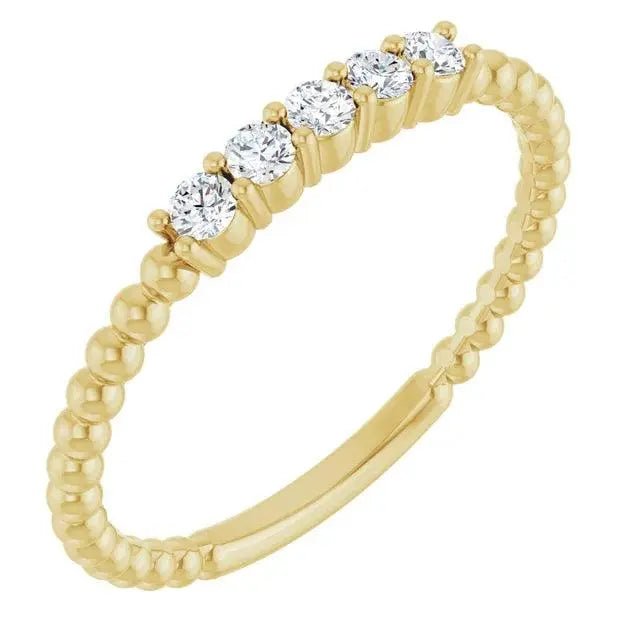 Close-up photo of 14K gold diamond stackable bead ring with natural diamonds, handcrafted in NYC.