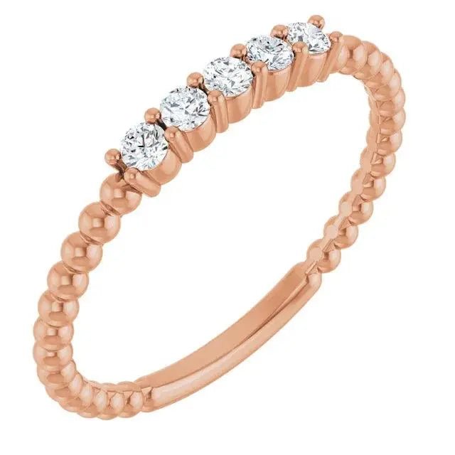14K rose gold diamond stackable bead ring with five round diamonds and a beaded texture. Perfect for layering or solo wear.