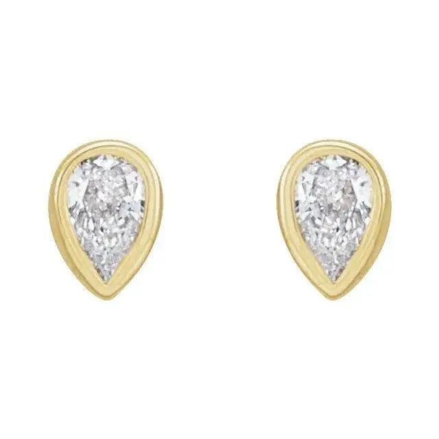 Close-up of gold earrings featuring bezel-set pear diamonds