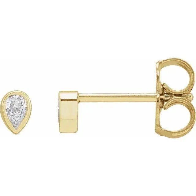 Close-up photo of 14K gold pear diamond bezel stud earrings with natural diamonds, handcrafted in NYC.