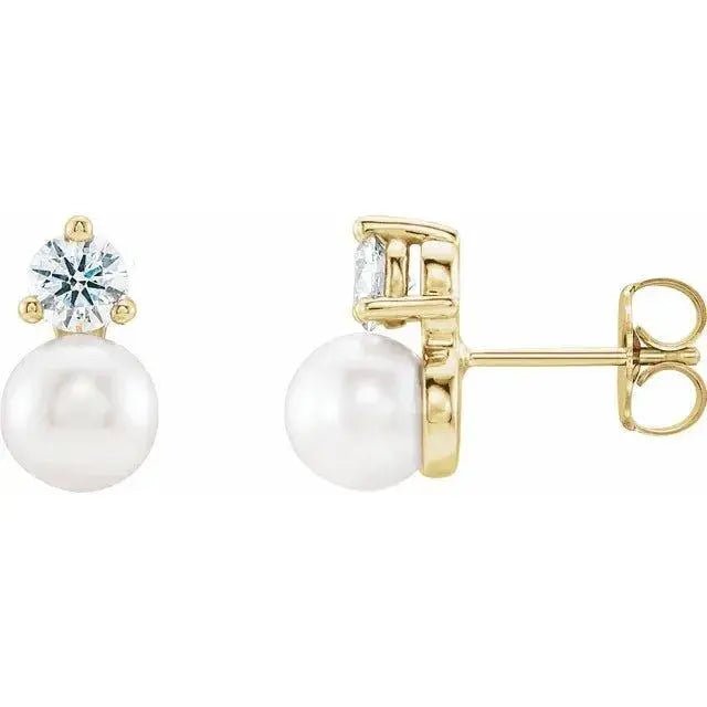 Close-up photo of 14K gold pearl diamond drop earrings with natural pearls and diamonds, handcrafted in NYC.