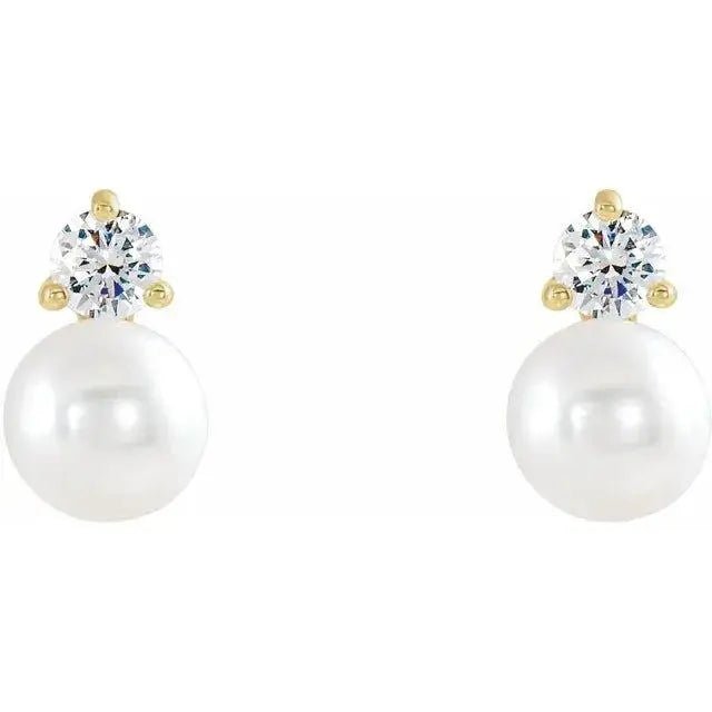 Close-up of 14K gold earrings featuring pearls and diamonds