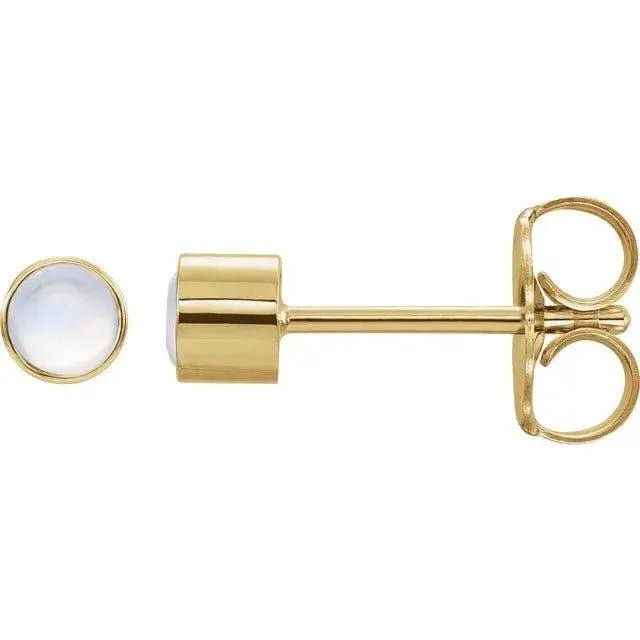 Close-up photo of 14K gold bezel-set moonstone stud earring, handcrafted in NYC.