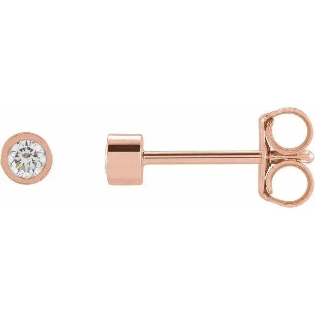 Close-up of round diamond stud earrings with sleek bezel design