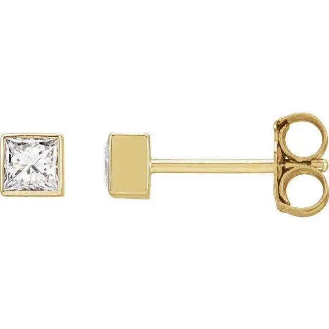 Close-up photo of 14K gold square diamond bezel stud earrings, handcrafted in NYC.