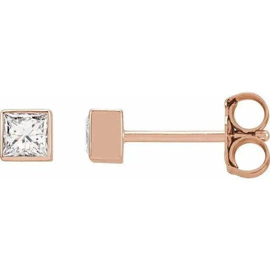 Luxury gold earrings featuring princess-cut diamonds in a bezel setting