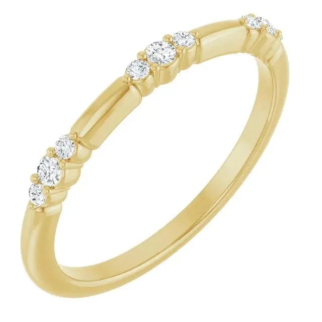 14K gold stationed diamond stackable ring featuring brilliant-cut diamonds along a sleek yellow gold band. Perfect for stacking or solo wear.