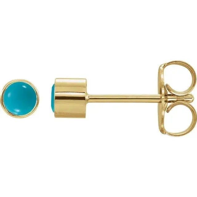 Close-up photo of 14K gold bezel-set turquoise stud earrings, handcrafted in NYC.