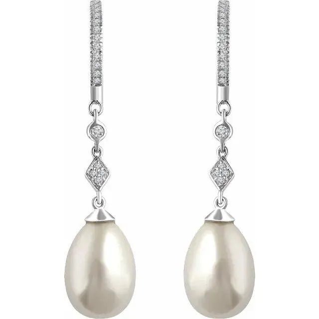 Close-up of elegant pearl drop earrings adorned with natural diamonds