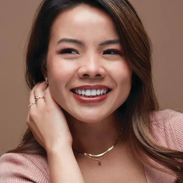 Elegant 14K gold 14mm diamond hoop earrings styled with a chic evening outfit, showcasing timeless sophistication and luxury.