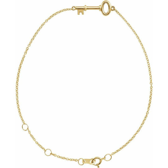 Close-up of the Petite Key Bracelet in 14K gold, featuring an 18.5mm x 6.5mm key charm and delicate 1mm chain.