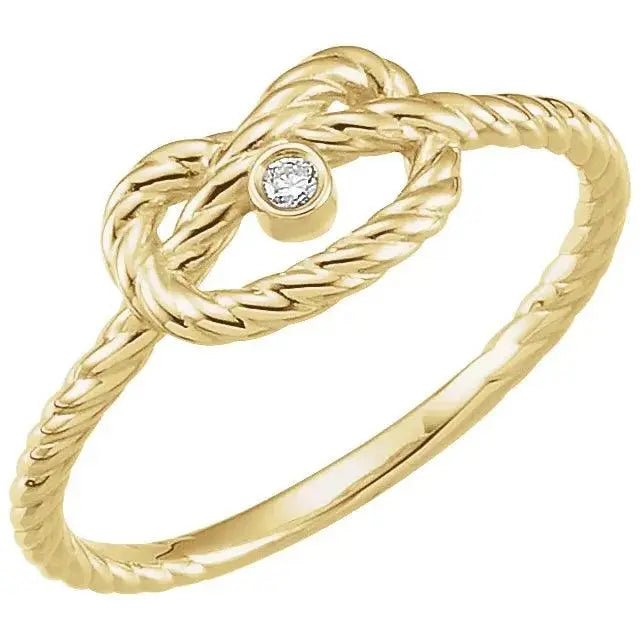 Close-up photo of 14K gold love knot ring with symbolic knot design, handcrafted in NYC.
