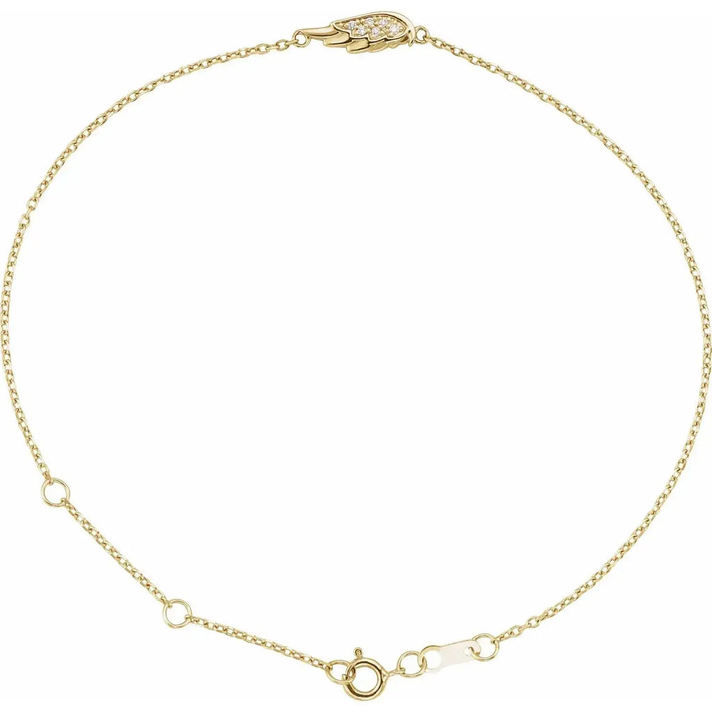 Close-up photo of 14K gold angel wing bracelet set with natural diamonds, handcrafted in NYC.
