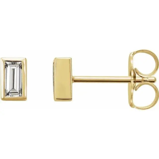 Close-up photo of 14K gold bezel-set baguette diamond stud earrings, handcrafted in NYC.
