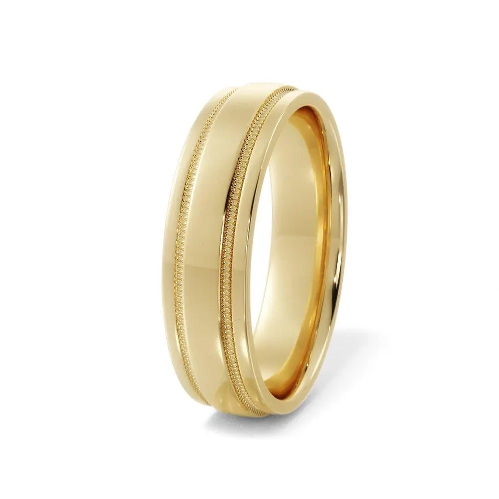 Close-up of a 6mm 14K gold wedding ring with grooved center and milgrain edges, handcrafted in NYC.