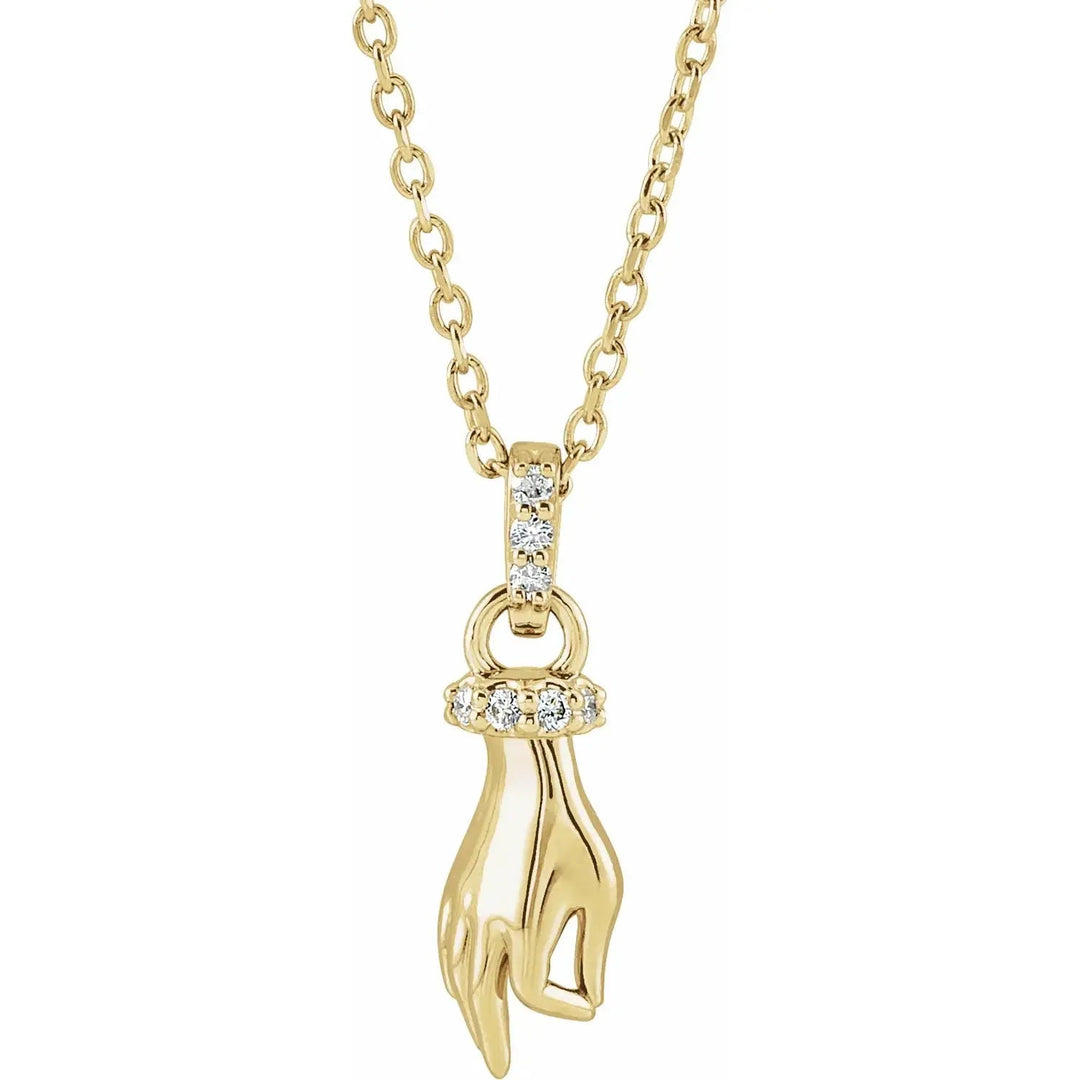 Buddha Hand Diamond Necklace in 14K gold featuring a delicate hand motif with a diamond-accented ring and bail, suspended on a fine gold chain.