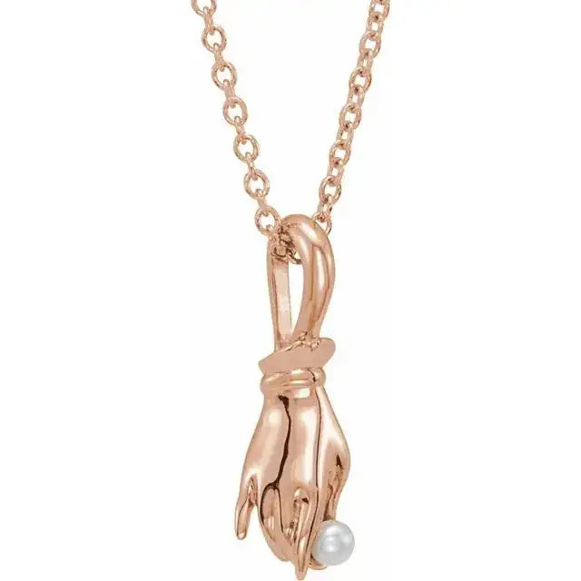 Timeless pearl necklace with spiritual Buddha hand motif