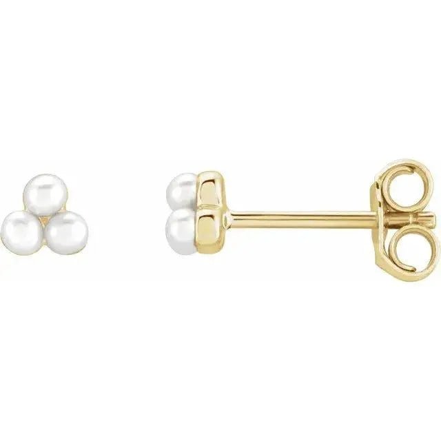 Close-up photo of 14K gold cluster pearl earrings with natural freshwater pearls, handcrafted in NYC.