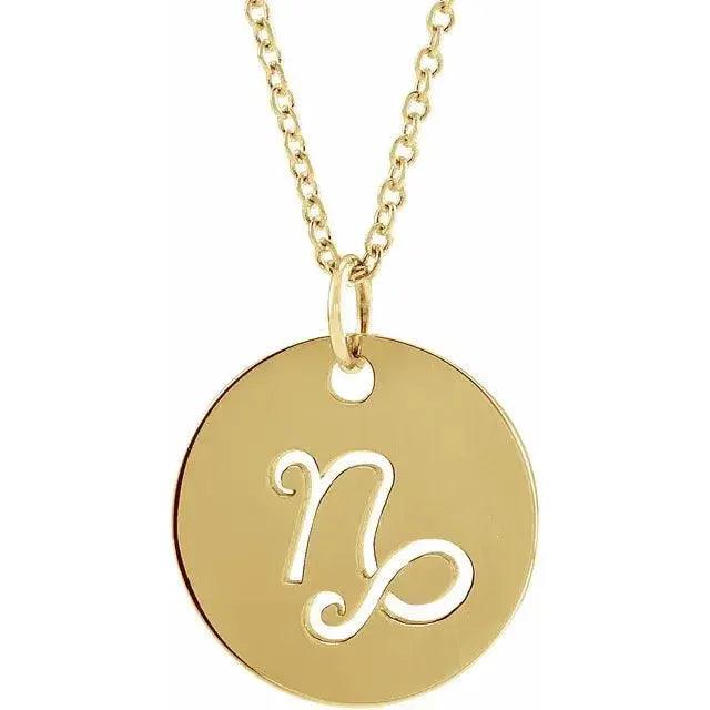 Close-up of Capricorn zodiac disc necklace in 14K gold, showcasing elegant engraving