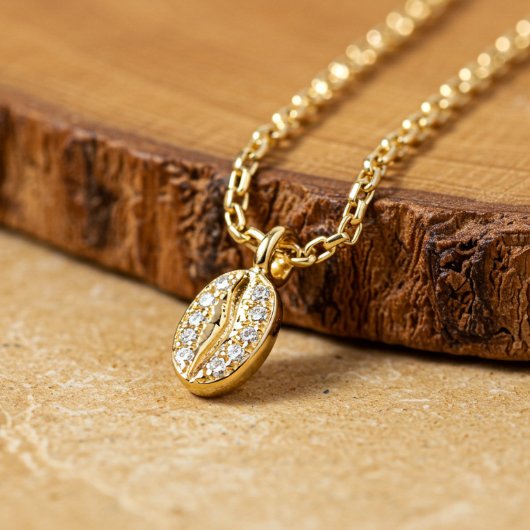 Elegant coffee bean pendant necklace with diamonds in 14K yellow gold – a handmade symbol of energy and luxury