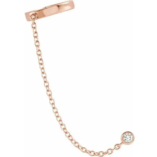 Rose gold diamond ear cuff with chain, made from 14K solid gold and adorned with a natural diamond. A trendy and sophisticated jewelry piece.