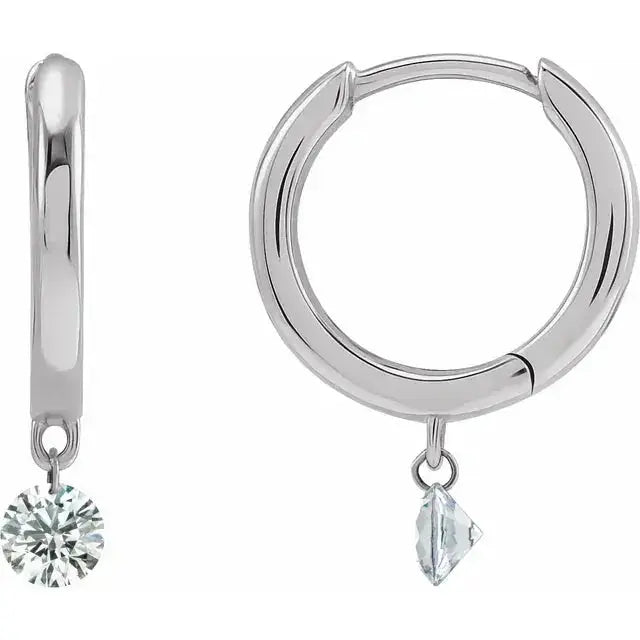 Drilled Natural Diamond Hoop Earrings in 14K white gold with a suspended diamond. A sophisticated and timeless jewelry piece with a modern floating diamond effect.