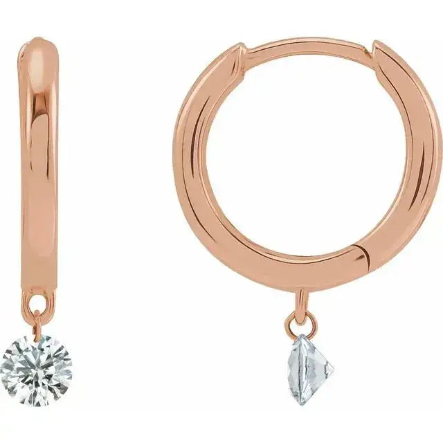 Drilled Natural Diamond Hoop Earrings in 14K rose gold with a floating diamond design. Hinged hoops showcasing 0.30 carats of natural diamonds for a refined look.