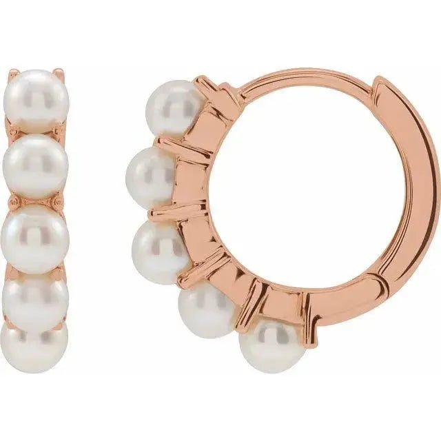 Rose gold hoop earrings featuring elegant pearl drops