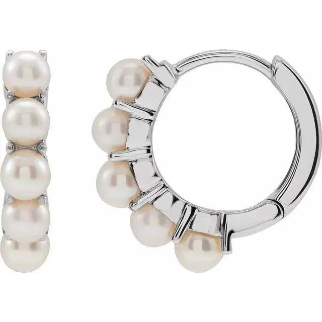 White gold huggie pearl earrings with a modern design