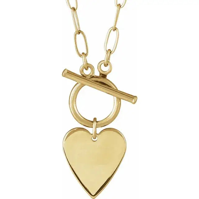 Close-up of a 14K gold Heart Necklace featuring a smooth, engravable 15.5mm pendant on an 18” chain.
