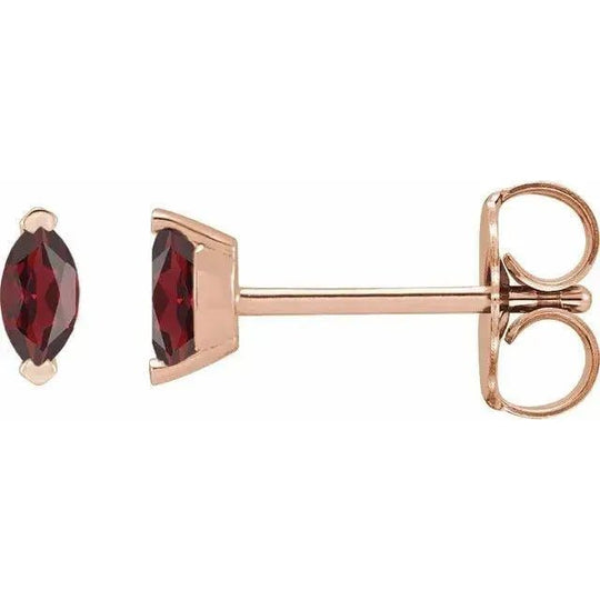 Close-up of luxurious natural garnet earrings with a sleek gold setting.