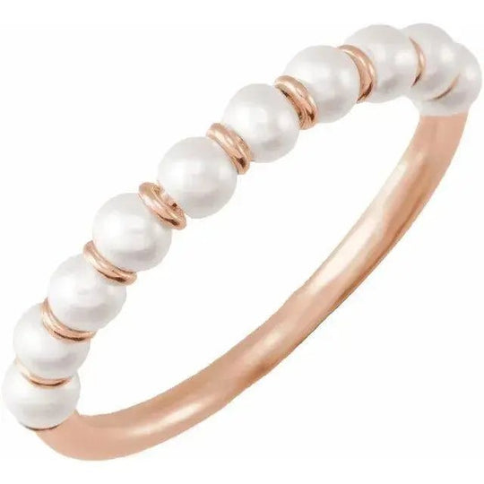 Close-up of 14K gold ring with linear pearl arrangement