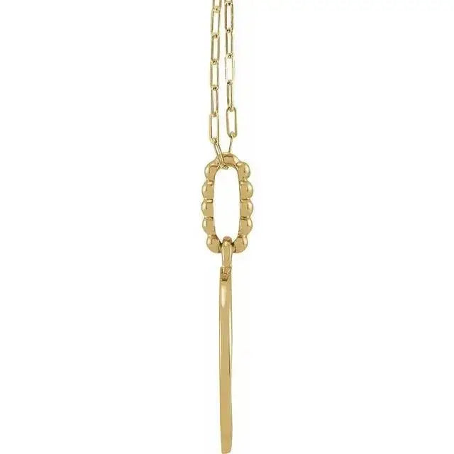Side view of the 14K gold evil eye necklace showcasing its intricate beaded connector and sleek pendant design.