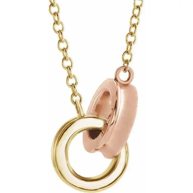 Close-up of interlocking circle pendant necklace in yellow gold