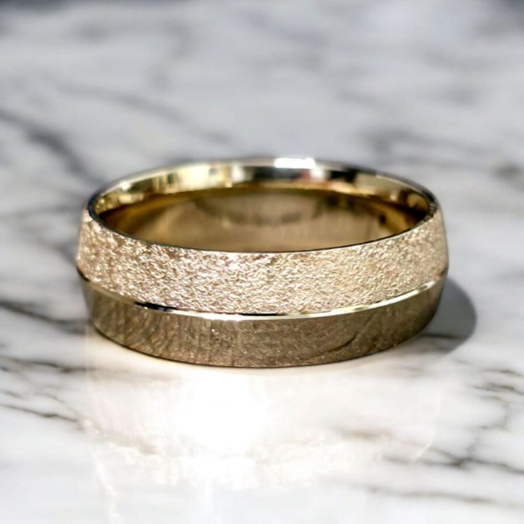 7mm knife edge wedding ring in 14K yellow gold with stone and polish finish