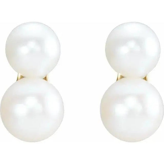 Close-up of lustrous pearl earrings in 14K yellow gold