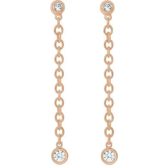 Close-up of diamond dangle earrings with modern chain design