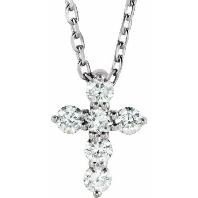 White gold mini diamond cross necklace featuring six natural diamonds on an adjustable 16-18 inch chain. A timeless and faith-inspired jewelry piece.