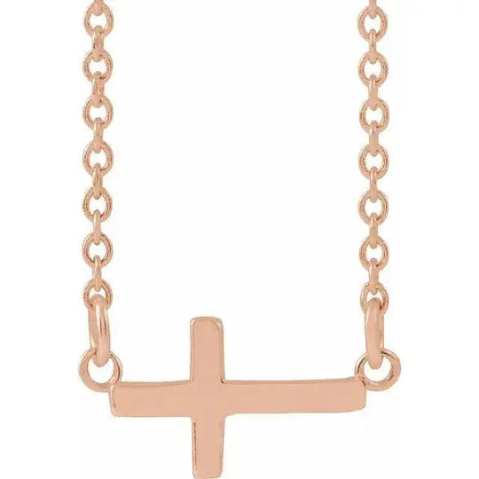 Mini Sideways Cross Necklace in 14K rose gold with a petite cross pendant. A meaningful and stylish accessory for a modern, minimalist look.