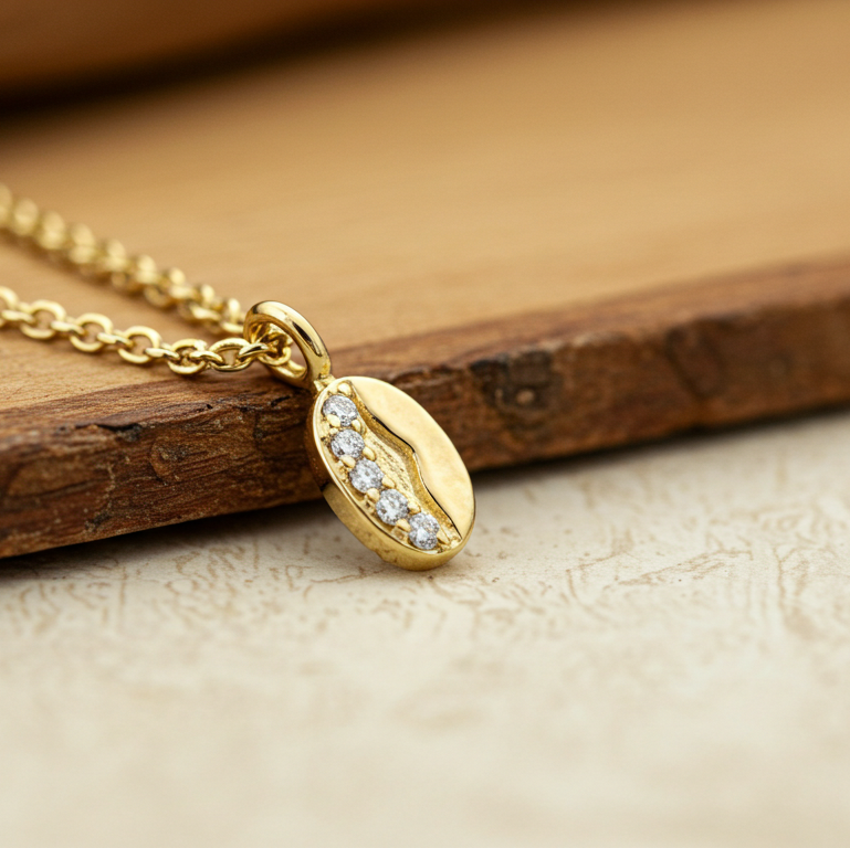 Delicate 14K gold coffee bean pendant with four diamond accents – minimalist fine jewelry made in USA