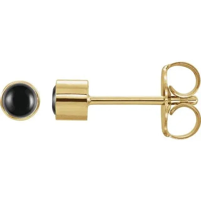 Close-up photo of 14K gold black onyx stud earrings with natural polished onyx stones, handcrafted in NYC.