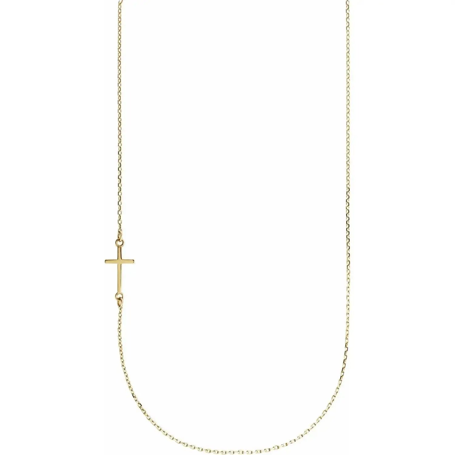 Close-up photo of an off-center sideways cross necklace handcrafted in 14K gold in NYC.