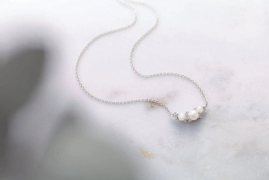 White Pearl Necklace adorned with .08 CTW Natural Diamond Jimmy Leon Fine Jewelry