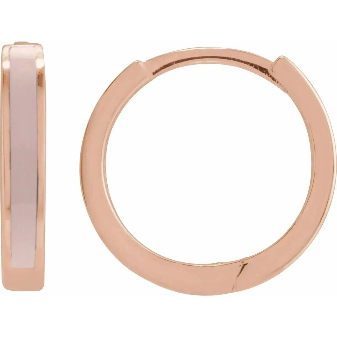 Rose gold pink enamel hoop earrings with a sleek, modern design. Crafted in solid gold, these hinged hoops add a touch of sophistication to any look.